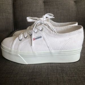 White Superga platform shoes.